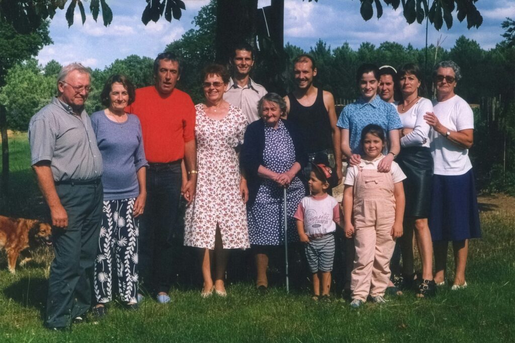 Multi-generational family together on a sunny lawn