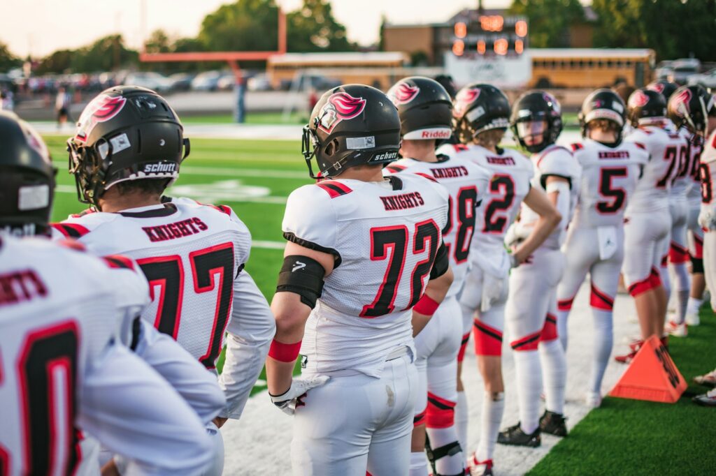 Football team walking onto the field in matching jerseys